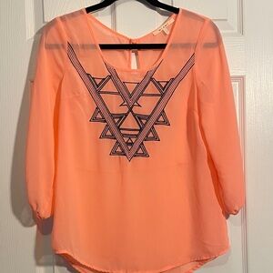 miami brand top in neon light orange with navy blue detail.